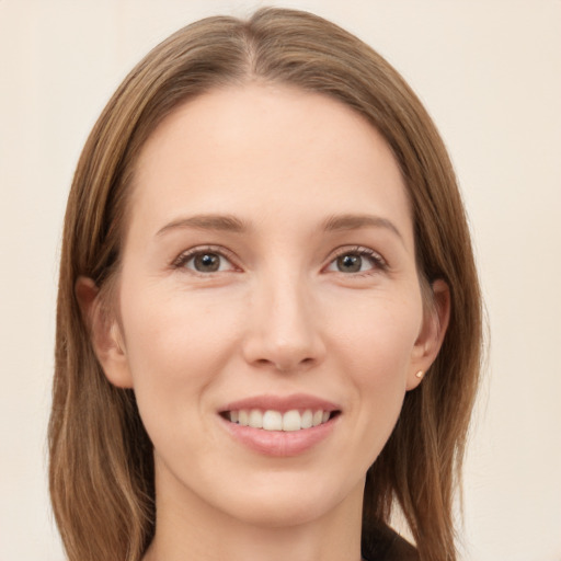 Joyful white young-adult female with long  brown hair and grey eyes