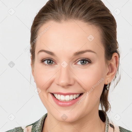 Joyful white young-adult female with medium  brown hair and blue eyes