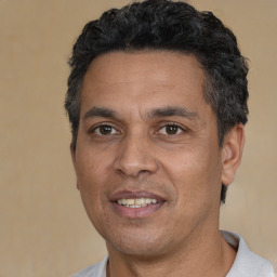Joyful white adult male with short  black hair and brown eyes