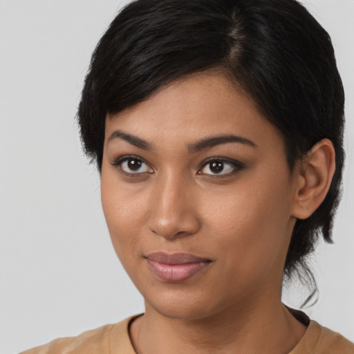 Joyful latino young-adult female with short  black hair and brown eyes