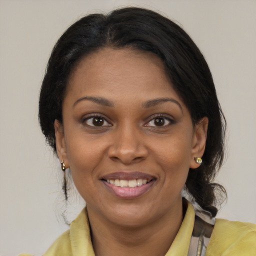Joyful black young-adult female with medium  brown hair and brown eyes