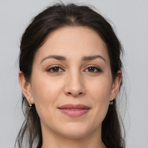 Joyful white adult female with medium  brown hair and brown eyes