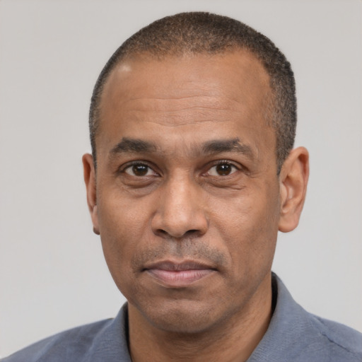 Neutral latino adult male with short  black hair and brown eyes