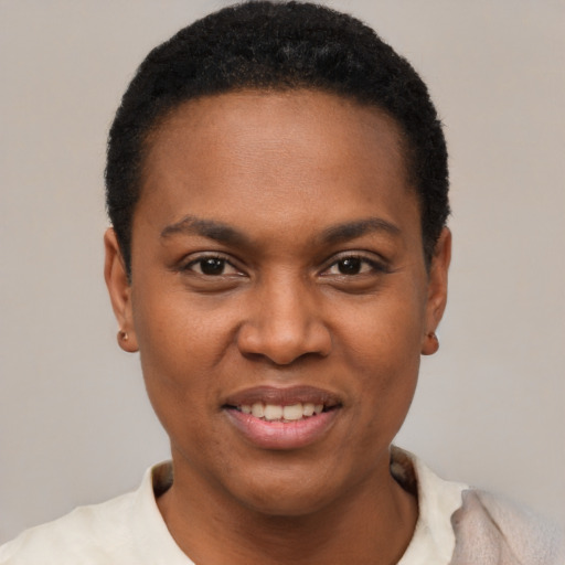 Joyful black young-adult female with short  black hair and brown eyes