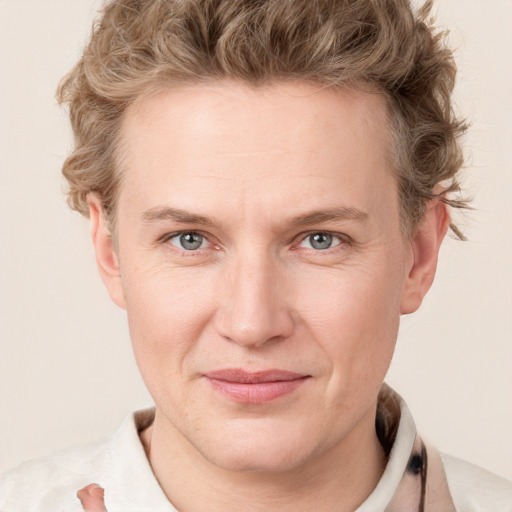 Joyful white young-adult male with short  brown hair and blue eyes