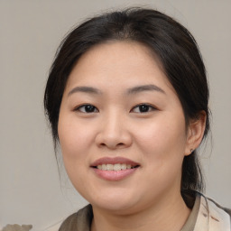 Joyful asian young-adult female with medium  brown hair and brown eyes