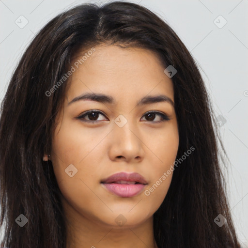 Joyful latino young-adult female with long  brown hair and brown eyes