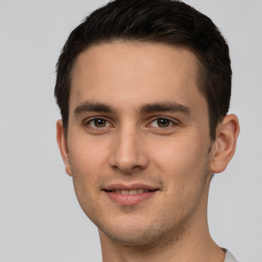 Joyful white young-adult male with short  brown hair and brown eyes