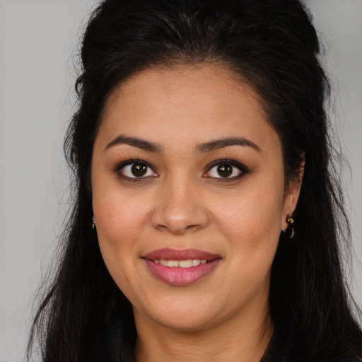Joyful latino young-adult female with long  brown hair and brown eyes