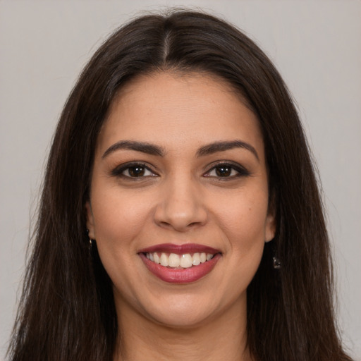 Joyful white young-adult female with long  brown hair and brown eyes