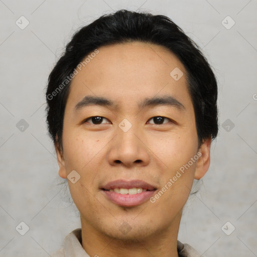 Joyful asian young-adult male with short  black hair and brown eyes