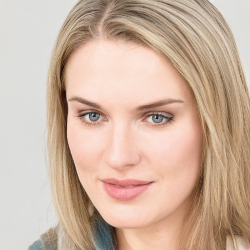 Joyful white young-adult female with long  brown hair and blue eyes