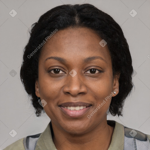 Joyful black adult female with short  black hair and brown eyes