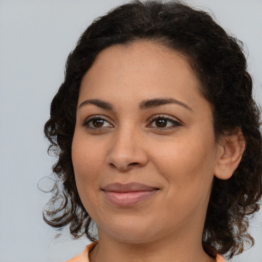 Joyful latino young-adult female with medium  brown hair and brown eyes
