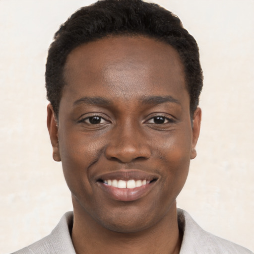 Joyful black young-adult male with short  black hair and brown eyes