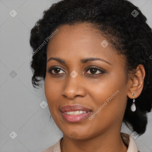 Joyful black young-adult female with long  black hair and brown eyes