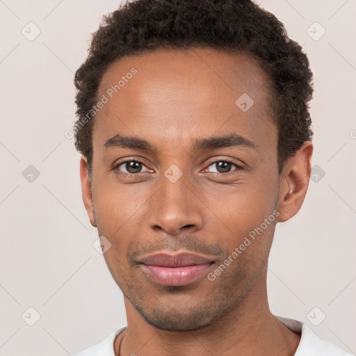 Joyful black young-adult male with short  brown hair and brown eyes