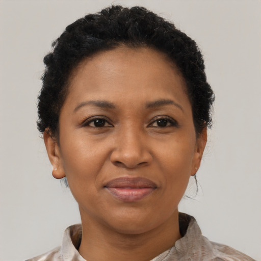 Joyful black adult female with short  brown hair and brown eyes