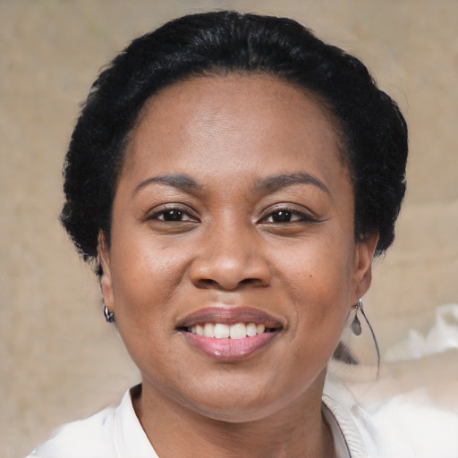 Joyful black adult female with short  black hair and brown eyes