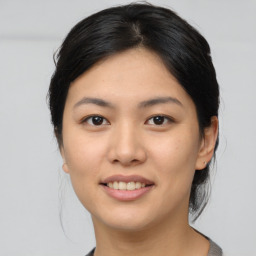 Joyful asian young-adult female with medium  black hair and brown eyes