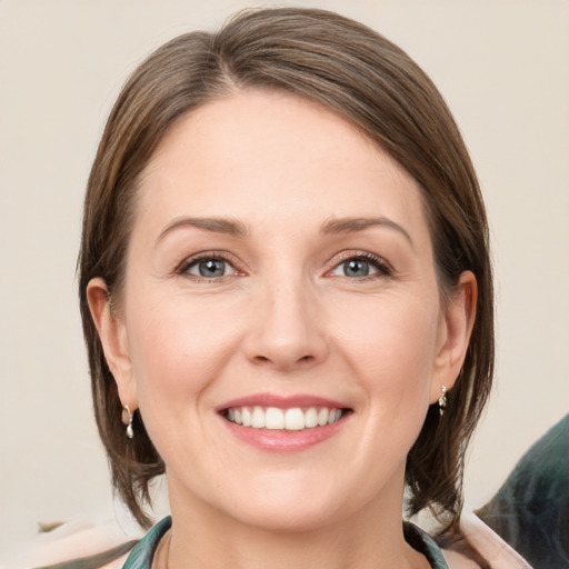 Joyful white young-adult female with medium  brown hair and grey eyes