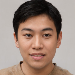 Joyful asian young-adult male with short  black hair and brown eyes