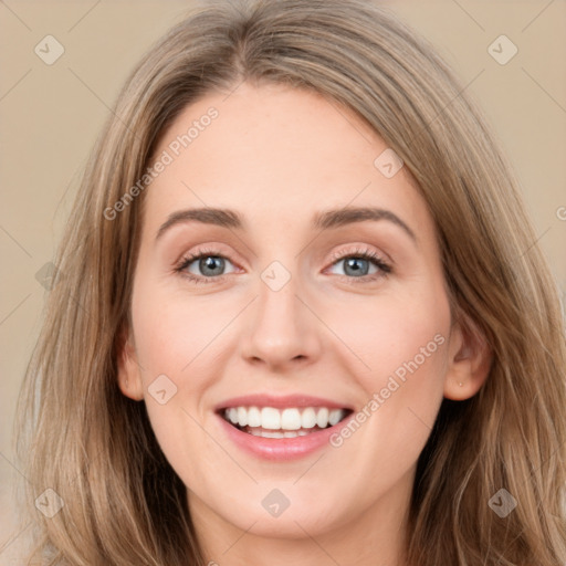 Joyful white young-adult female with long  brown hair and grey eyes