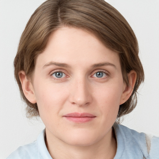 Joyful white young-adult female with medium  brown hair and blue eyes