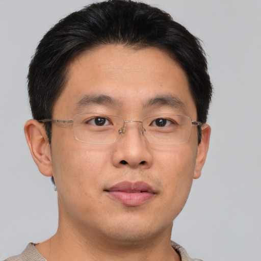 Joyful asian adult male with short  brown hair and brown eyes