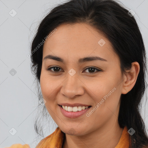 Joyful latino young-adult female with long  brown hair and brown eyes