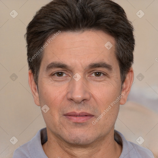 Joyful white adult male with short  black hair and brown eyes