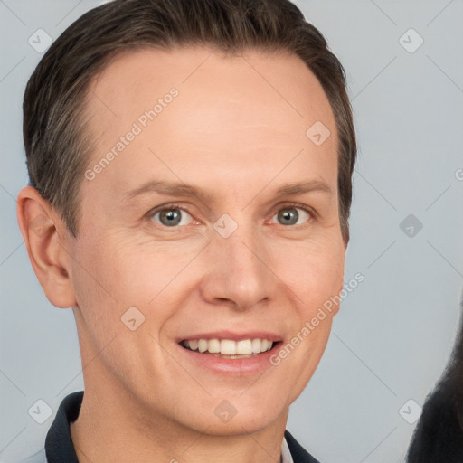 Joyful white adult male with short  brown hair and grey eyes