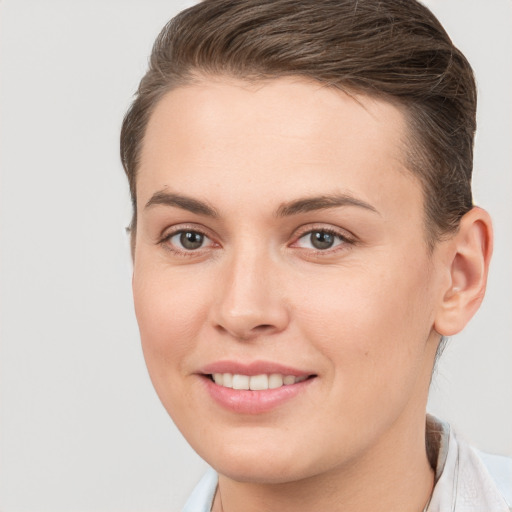 Joyful white young-adult female with short  brown hair and brown eyes