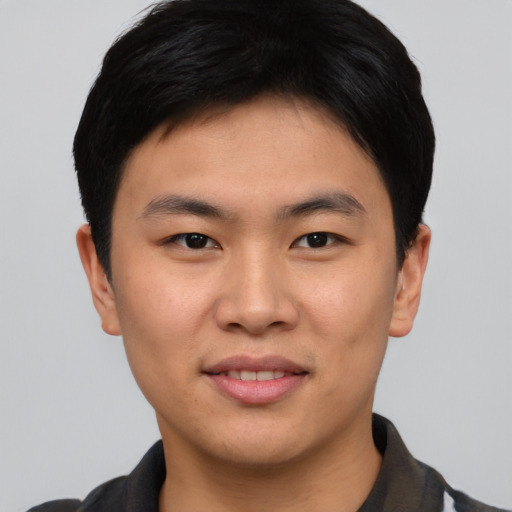 Joyful asian young-adult male with short  black hair and brown eyes