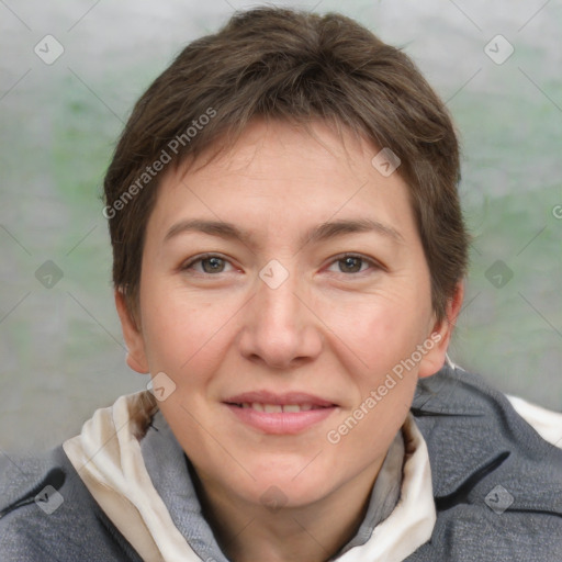 Joyful white adult female with short  brown hair and grey eyes