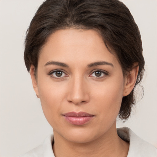 Joyful white young-adult female with medium  brown hair and brown eyes