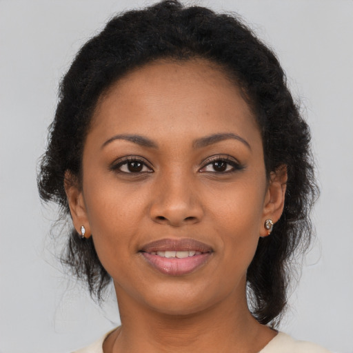 Joyful black young-adult female with short  brown hair and brown eyes