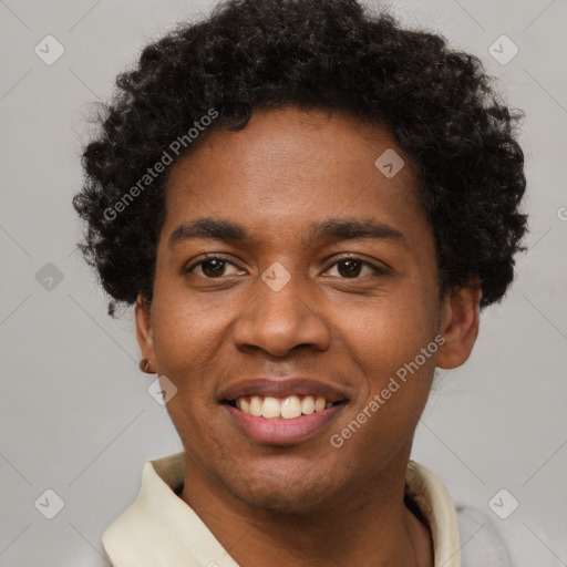 Joyful black young-adult male with short  brown hair and brown eyes