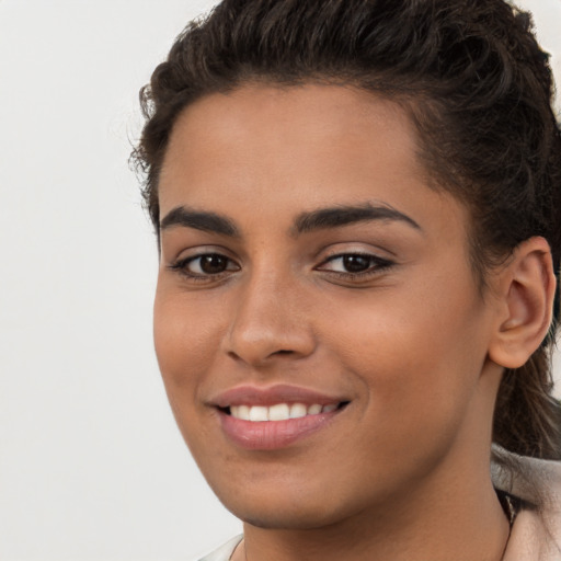 Joyful white young-adult female with long  brown hair and brown eyes