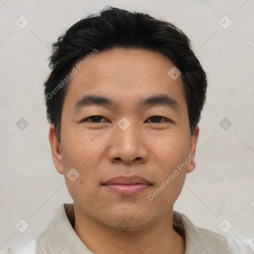 Joyful asian young-adult male with short  black hair and brown eyes