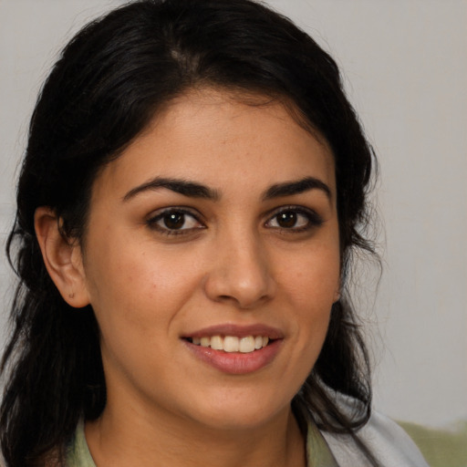 Joyful latino young-adult female with medium  brown hair and brown eyes