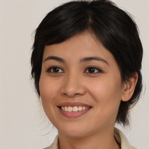 Joyful white young-adult female with medium  brown hair and brown eyes
