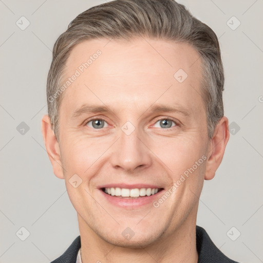 Joyful white adult male with short  brown hair and grey eyes