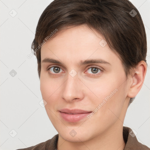 Joyful white young-adult female with short  brown hair and brown eyes