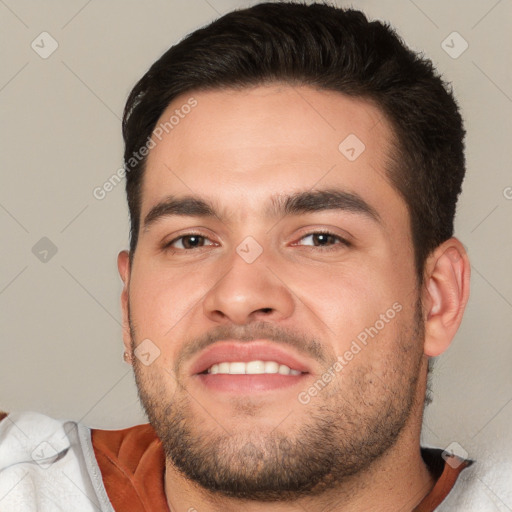 Joyful white young-adult male with short  brown hair and brown eyes