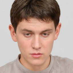 Neutral white young-adult male with short  brown hair and grey eyes