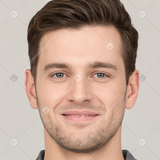 Joyful white young-adult male with short  brown hair and grey eyes