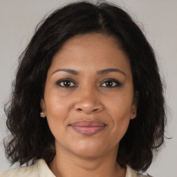 Joyful black adult female with medium  brown hair and brown eyes