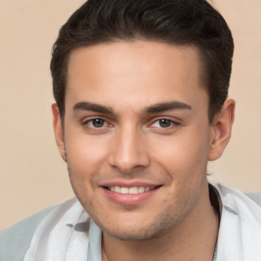 Joyful white young-adult male with short  brown hair and brown eyes