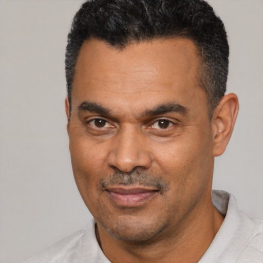 Joyful latino adult male with short  black hair and brown eyes
